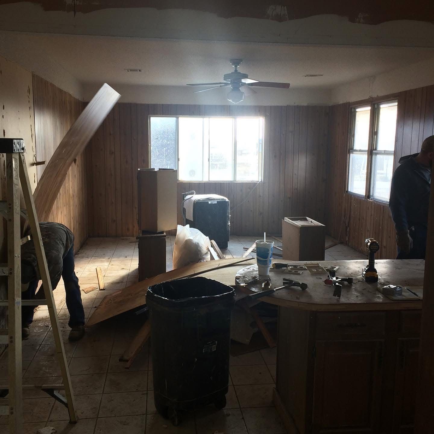 Room during demolition with wood paneling