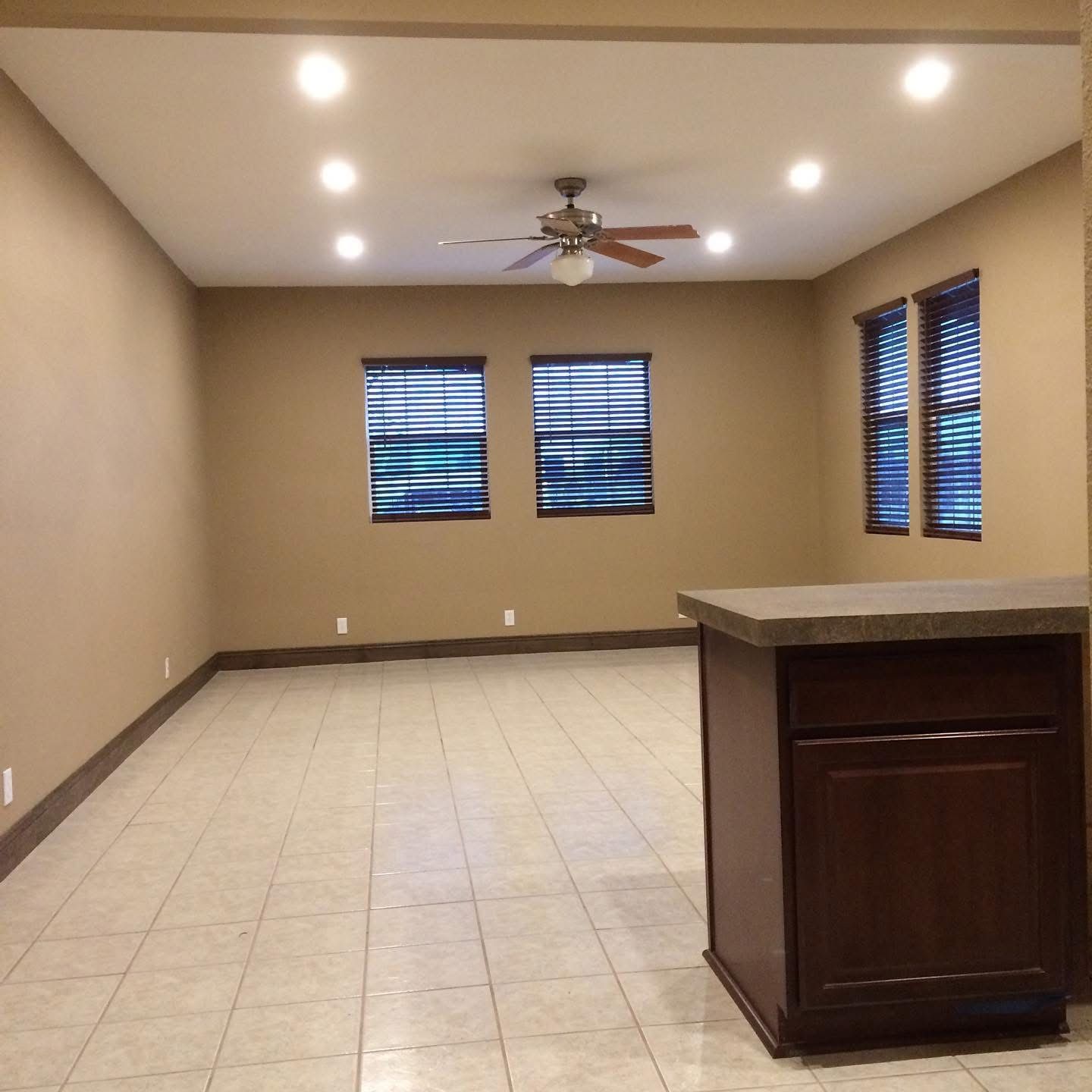 Remodeled room with fresh paint, recessed lighting and tile floor